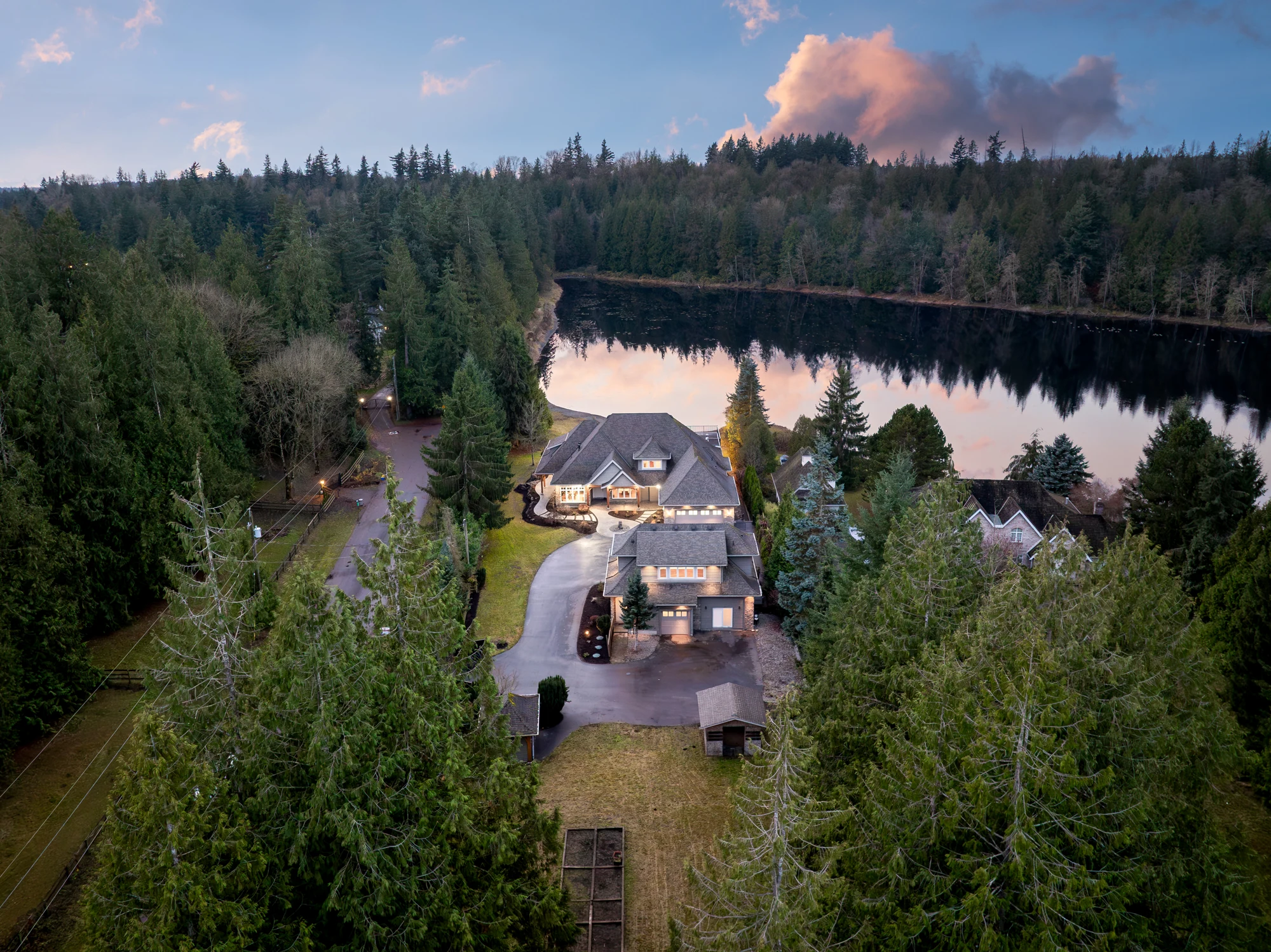 The lakefront estate at 23455 8 Avenue at sunset